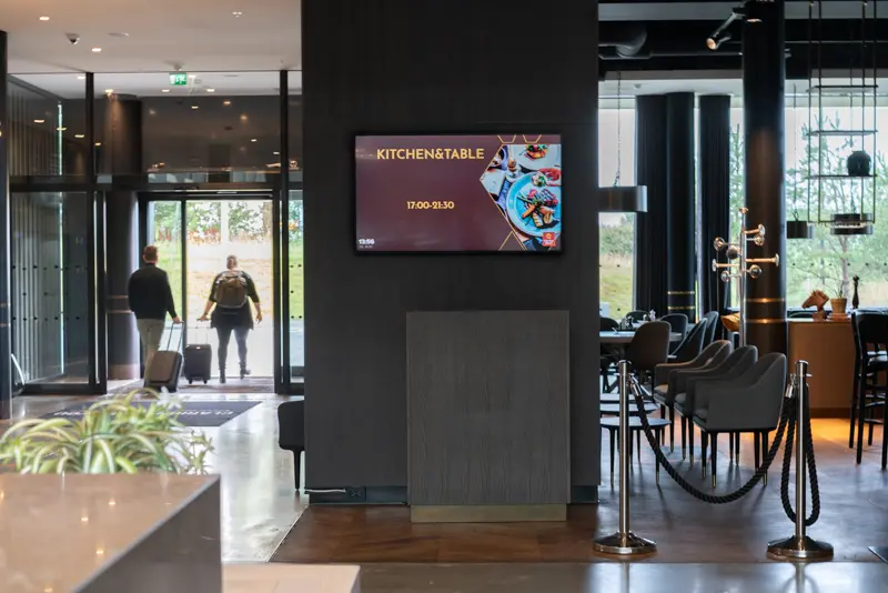 A public screen smartly placed between restaurant, reception and entrance at Clarion Hotel Air.