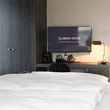 Hotel room with a hotel TV displaying PinToMind content.