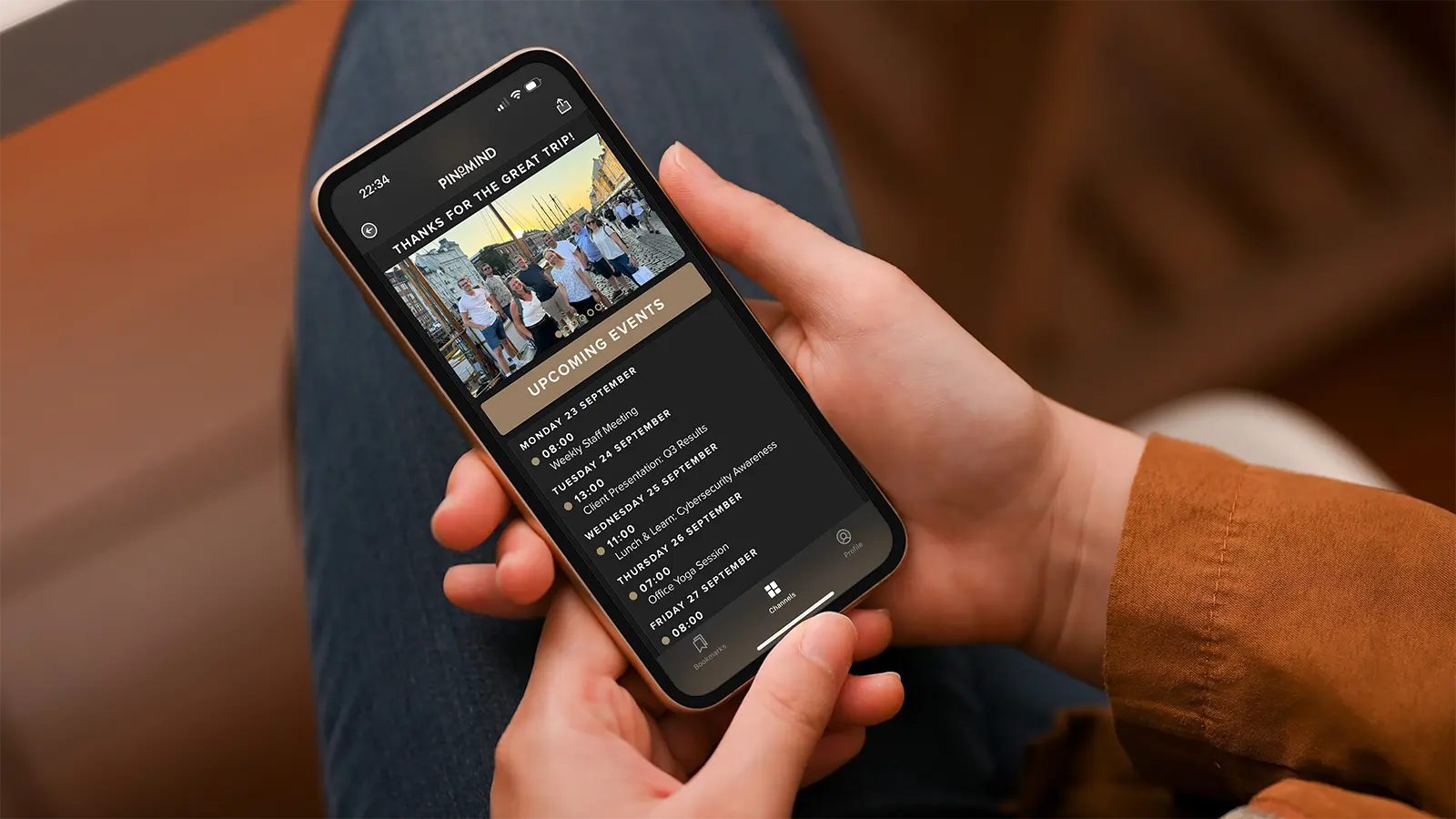 Photo of hands holding a mobile phone displaying Go in dark mode.